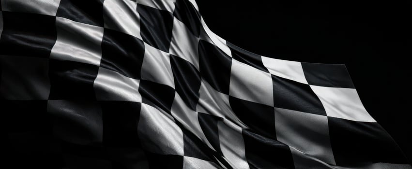 The checkered flag waving gracefully against a dark background. photo