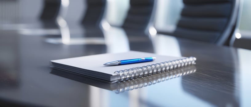 The sleek notebook and pen set on a modern conference table. photo