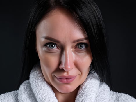 Serene woman in white bathrobe with a gentle smile photo