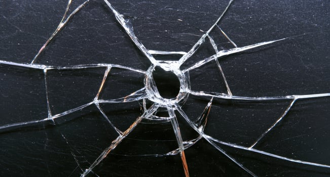 Cracked glass with a hole, showing damage and destruction photo
