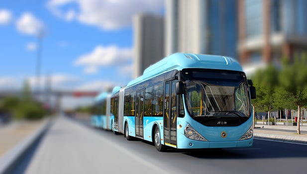 A blue bus driving down a street photo