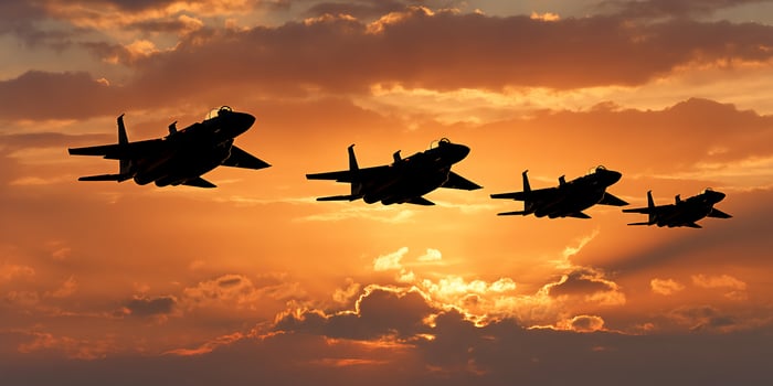 Jet silhouette against sunset clouds photo