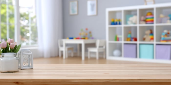 Playroom scene featuring tulips in the foreground with tables and toy shelves photo
