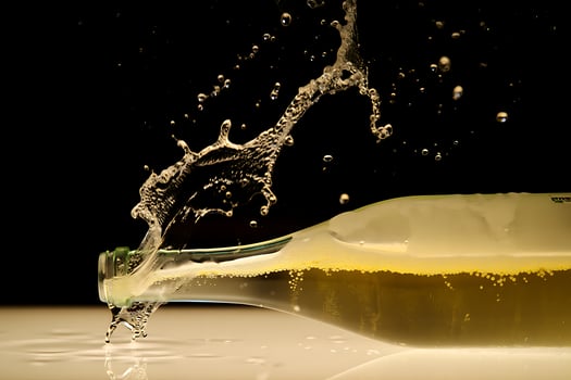 Champagne bottle splashing liquid against black background photo