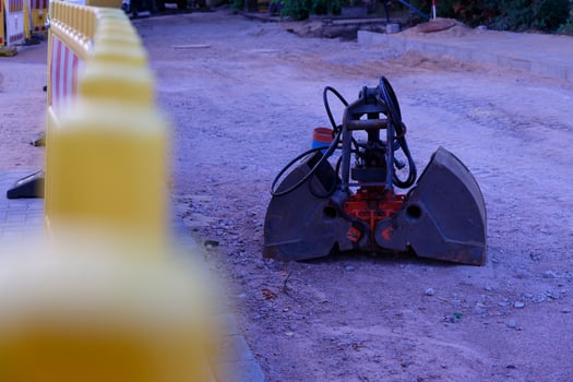 Road Work Zone with Plastic Fences and Excavator Bucket photo