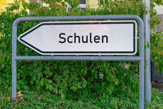 White Arrow Sign on Metal Pipes with German Text photo