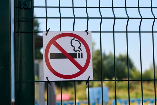 Please take notice of the No Smoking Sign located prominently on the Fence in the Outdoor Area photo