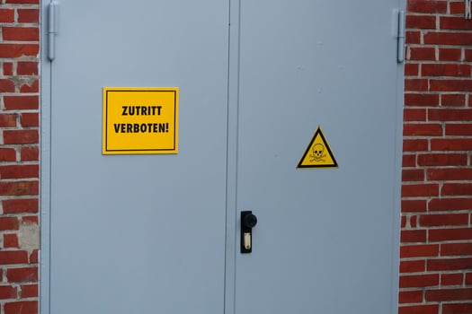 Red Building with Restricted Access and Danger Signs photo