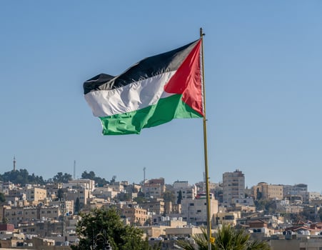 The large Palestinian flag is waiving above the city. photo