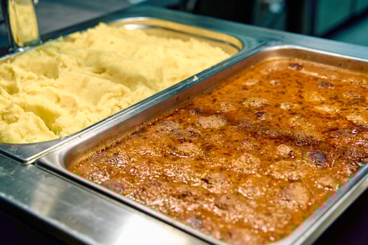 A Delicious Spread of Creamy Mashed Potatoes Paired with Flavorful Beef Meatballs in Rich Gravy for a Satisfying Meal Experience photo