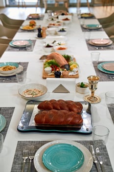 A Festive Table Setting with Exquisite Culinary Delights Featuring Artfully Arranged Dishes, Breads, and Vibrant Garnishes for a Memorable Gathering photo