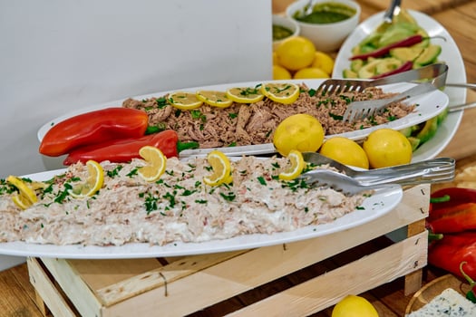 A Deliciously Plated Seafood Dish Garnished with Fresh Lemons and Vibrant Vegetables, Perfectly Arranged for an Inviting Culinary Experience. photo