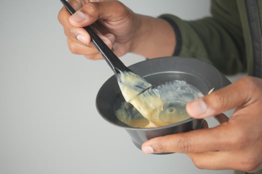 Mixing hair color in a black bowl with a brush photo