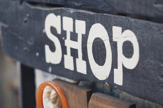 Unique shop sign displayed on rustic wooden surface photo