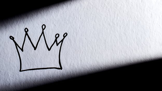 Simple Crown Drawing Emerges from Light and Shadow on Textured Surface. photo