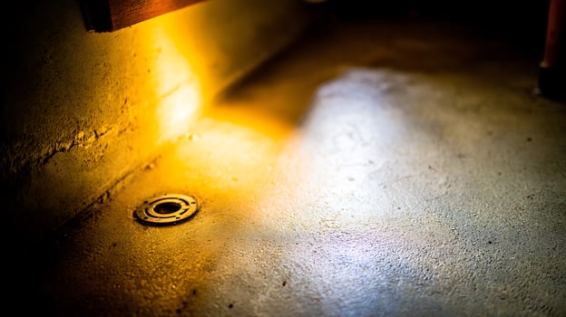 Warm Light Glows on Textured Floor with Drain. photo