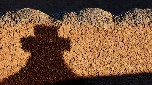 Textured Ground Shadow A Cross Shape in the Dust and Dirt. photo