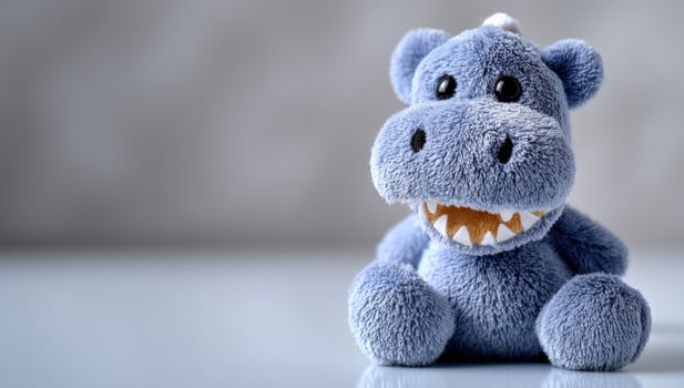 Hippo plush toy sitting. Great for kids and decoration. Light background photo