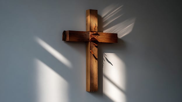Rustic Wooden Cross Illuminated by Natural Light and Shadows. photo