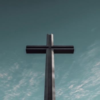 Majestic Concrete Cross Reaching Towards a Cloudy Sky. photo