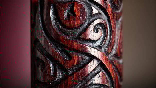 Intricate Red Wood Carving with Dark Swirls and Texture. photo