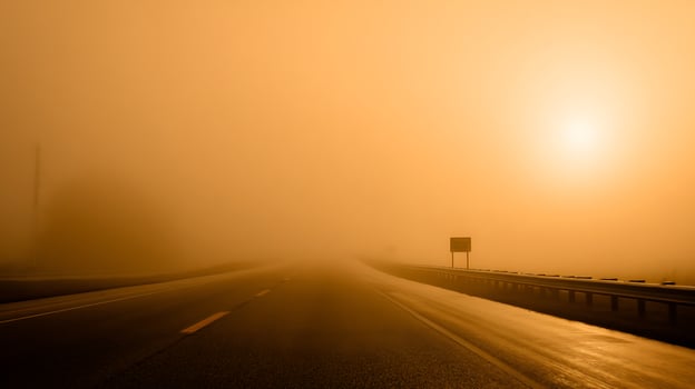 Journey into the unknown through the misty road at dawn. photo