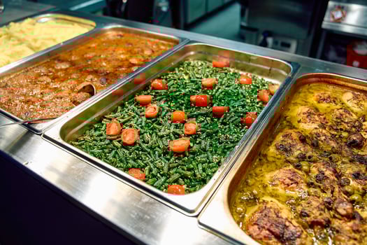 A Delectable Array of Culinary Delights Featuring Chicken, Green Beans, and Herb-Infused Sauces in a Vibrant Buffet Setting photo