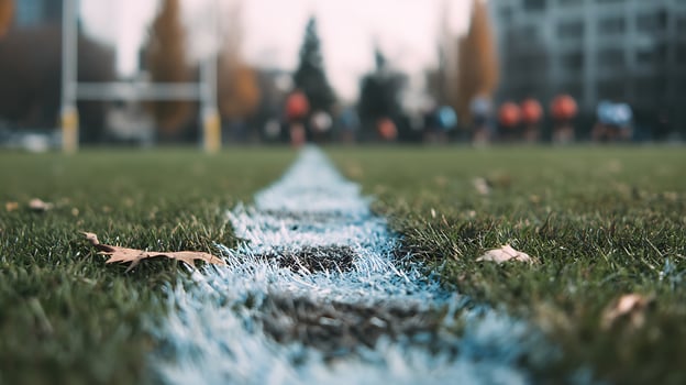 Rugby field line focus with blurred players and goals in background. photo