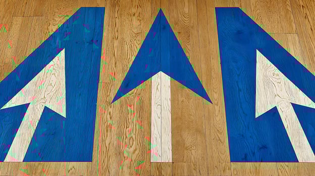Bold Blue and White Arrows Point Forward on Textured Wood. photo