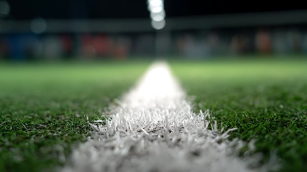 Close Up Focus on Soccer Field Line Under Stadium Lights. photo