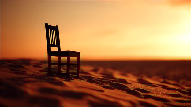 Lone chair on a sand dune at sunset creates a feeling of solitude. photo