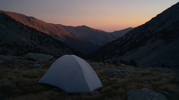 Tent in Mountains at Sunrise, Serene Wilderness Camping Adventure. photo