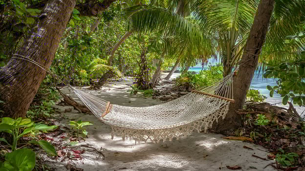 Tropical paradise hammock awaits relaxation by the turquoise sea. photo