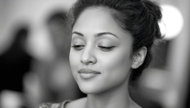 Portrait of a woman with a soft smile looking down. Black and white photo