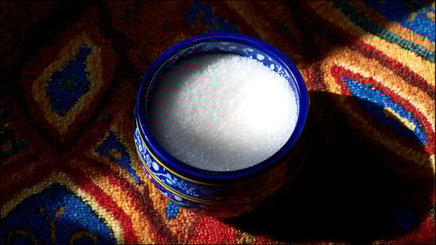 A Bowl of Sugar on a Vibrantly Colored Textured Background. photo