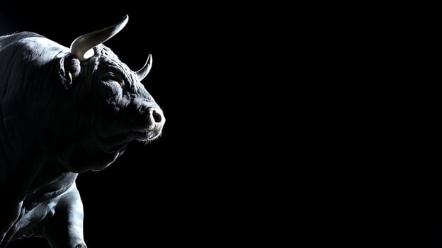 Majestic Bull Standing in Dramatic Light Against a Dark Background. photo