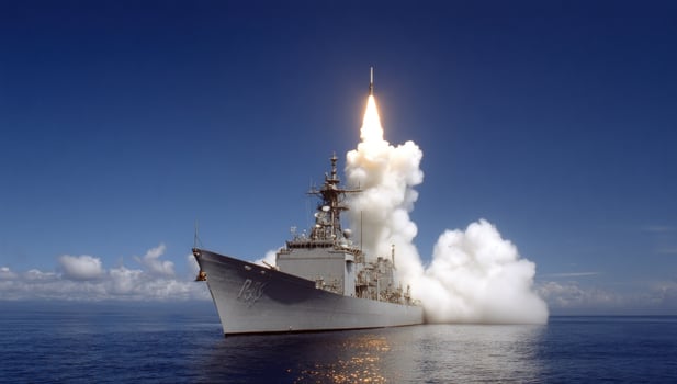 Warship missile launch at sea, defense demonstration against a blue sky photo