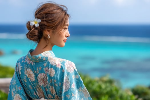 Woman in kimono gazes out over turquoise ocean. Tourism, cultural promotion photo