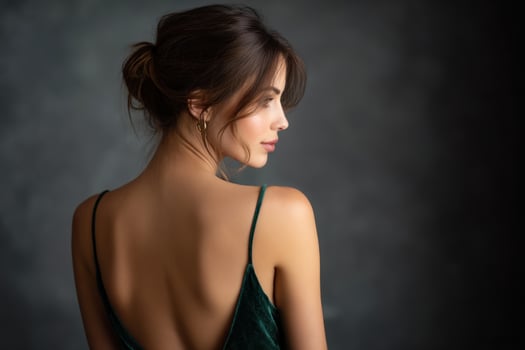 A woman in a green dress with a backless dress photo