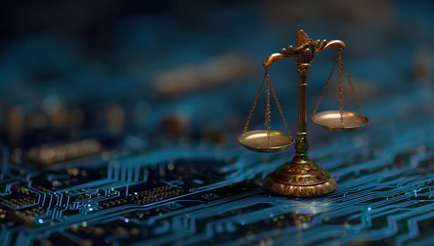 Golden scales of justice sit atop a circuit board, a study in technology and ethics photo