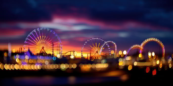 A blurry photo of a ferris wheel at night