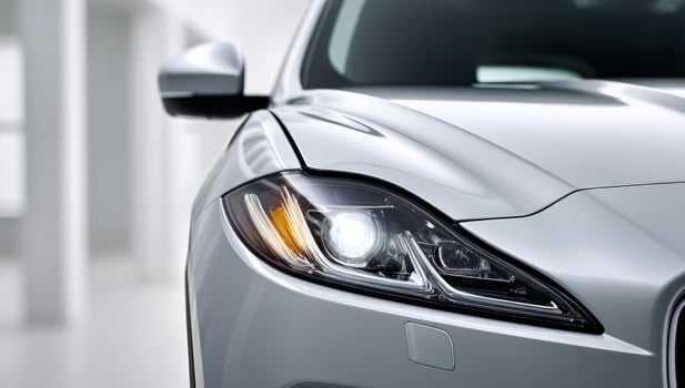 The front end of a silver jaguar car photo