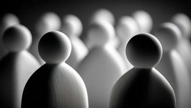 Crowd of figurines stand in dark gray background. Grouping of faceless statues photo