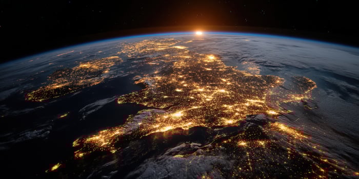 Earth from space at night showing city lights and a sunrise with stars photo