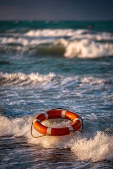 An orange life preserver on the beach photo