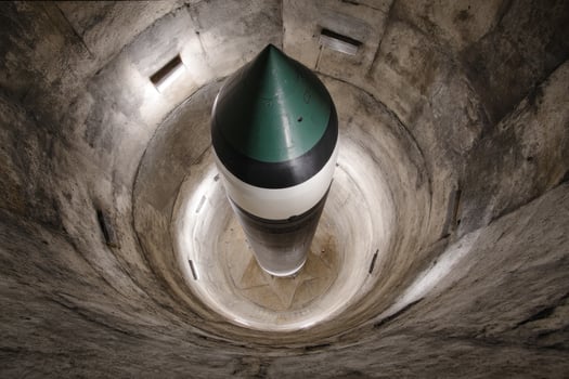 Missile poised in silo, view from below, concrete structure, indirect lighting photo
