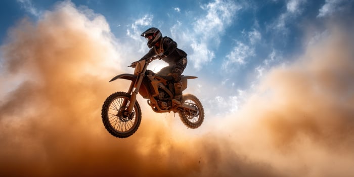 Motocross rider jumping over a cloud photo
