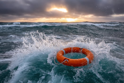 Orange Life Preserver sits in ocean waves with light breaking through storm clouds photo