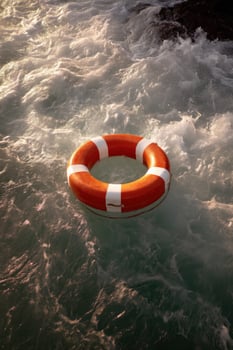 An orange life preserver floating in the ocean photo