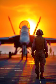 Pilot walking on aircraft carrier deck at sunset, backlit by the setting sun photo